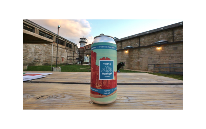 Can of purpose pale ale sitting outside on a picnic table
