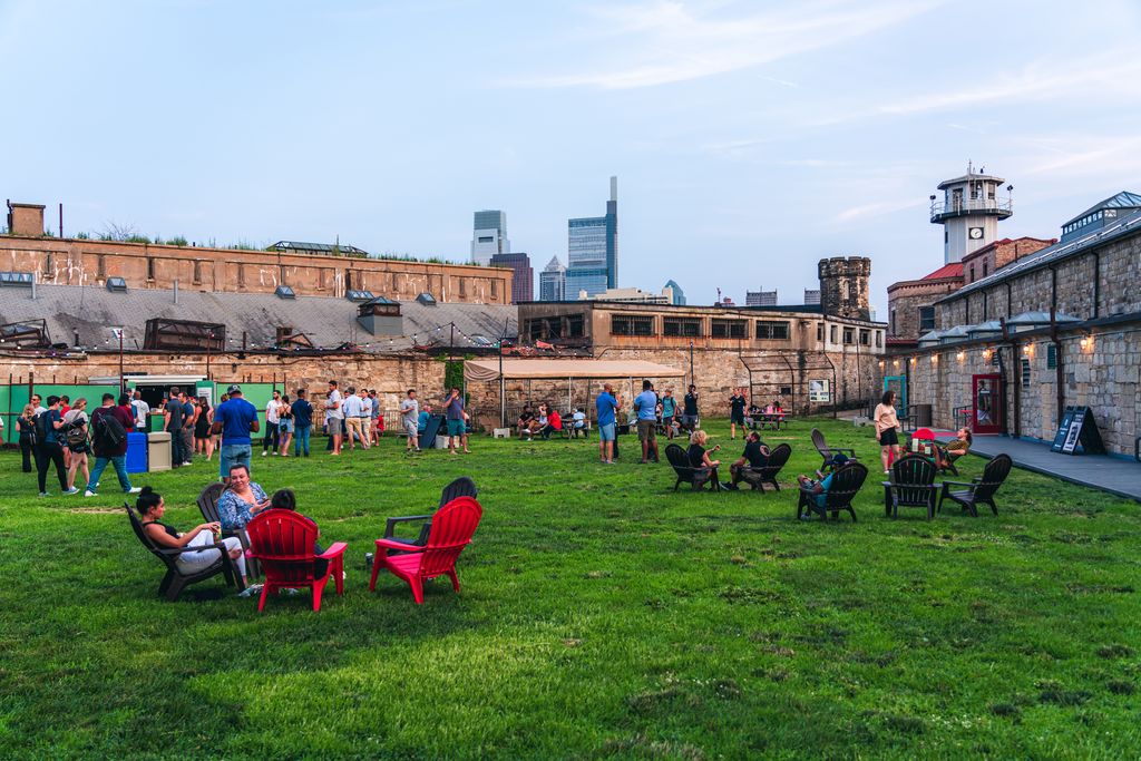 People gather on the baseball field at Eastern State Penitentiary Historic Site.