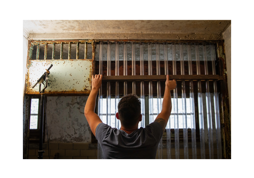 Mark Menjivar installs clear acryilic bars into Eastern State's historic Death Row
