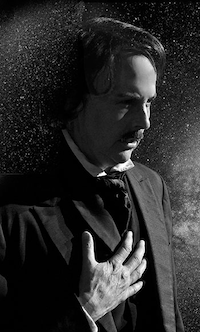 a black and white photo of Helen McKenna dressed as Edgar Allan Poe