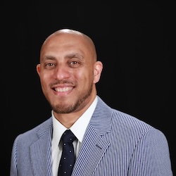 Hasan Kwame Jeffries smiles at the camera.
