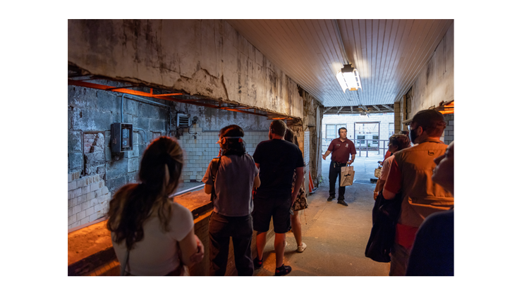 An educator leads a small group tour of the historic dining halls