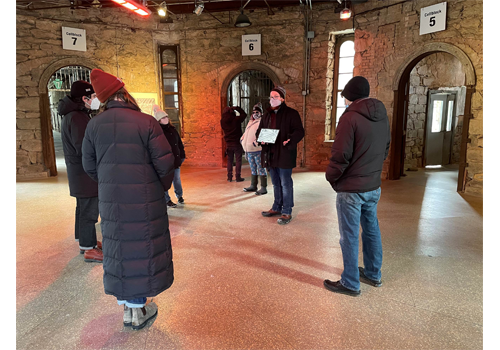 a group of people on a tour in the center of the penitentiary