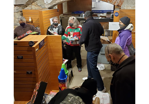 a group of people sorting toys into boxes