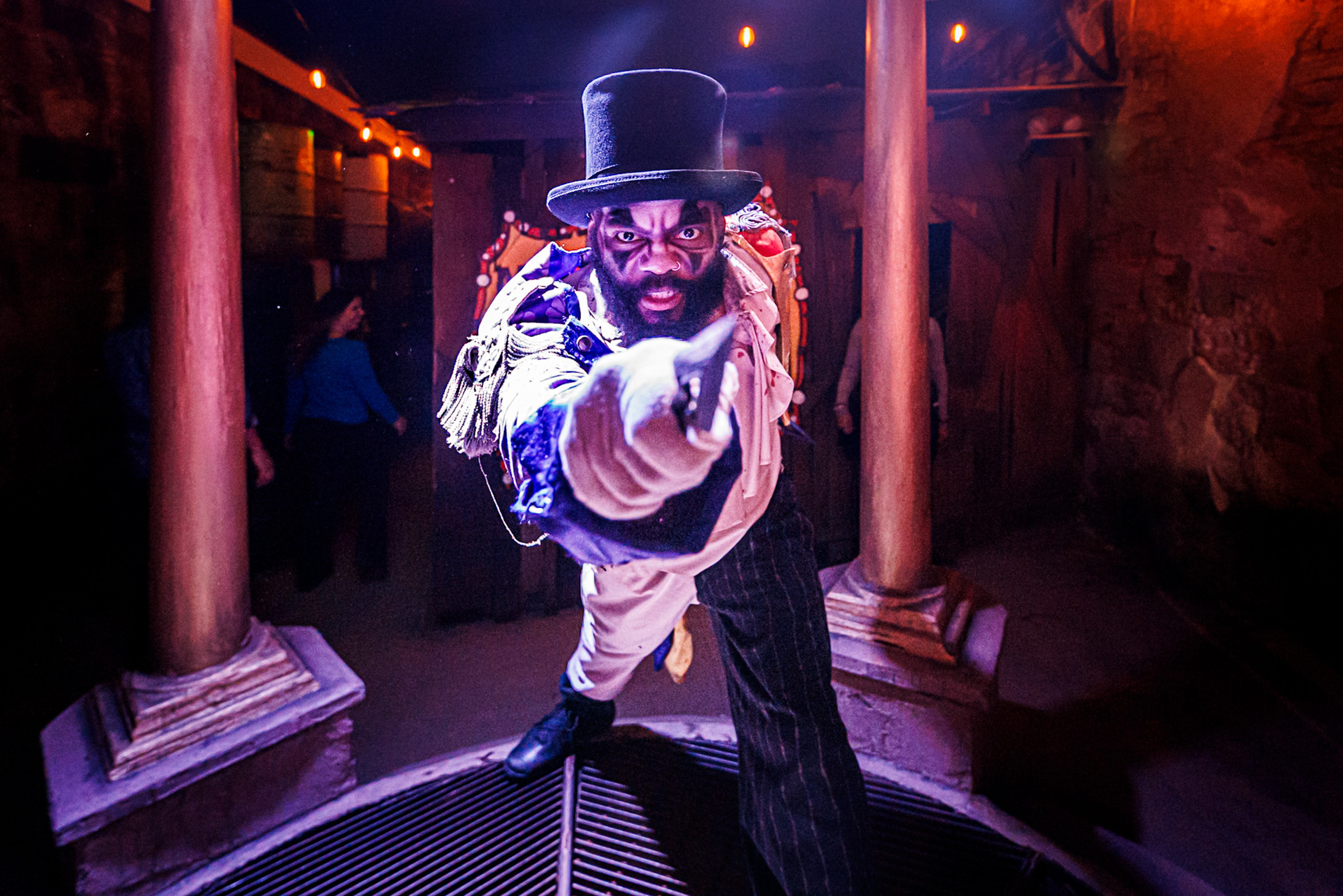 A terrifying circus barker pointing a knife directly at the viewer.