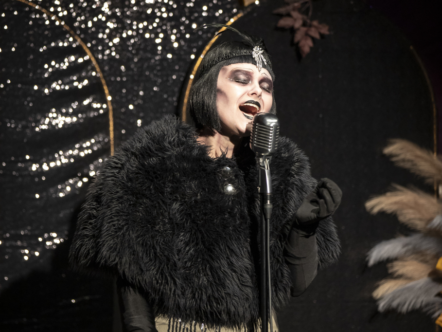 A photo of a ghostly flapper singing in The Speakeasy